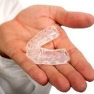 A mouth guard that cuts teeth, which is a symptom of the presence of parasites