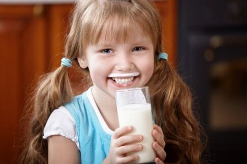 A girl drinks kefir to prevent parasites